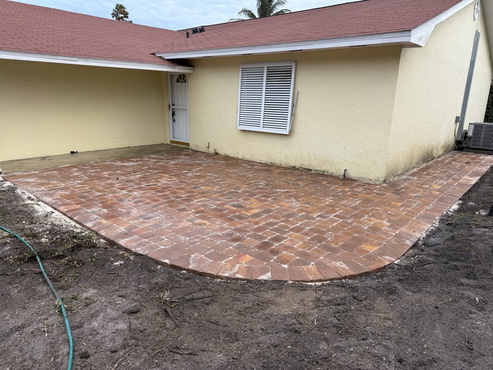 Paver patio beside a house, built by Groundworks in Brevard County